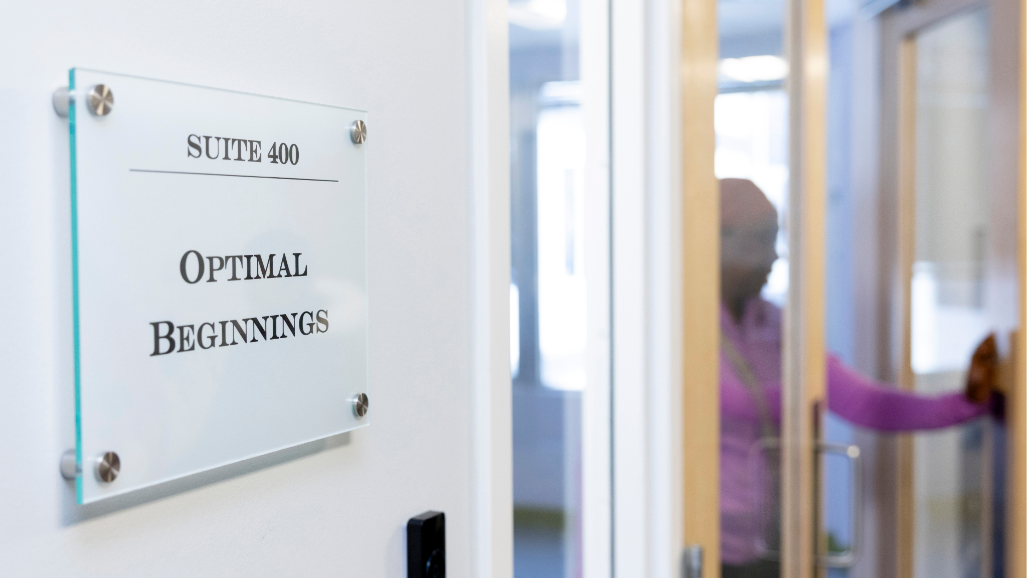 Blog Featured Image Image of office sign with a dark screen individual opening a door.
